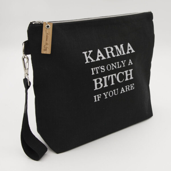 Black linen zipped bag with karma. It's only a bitch if you are print