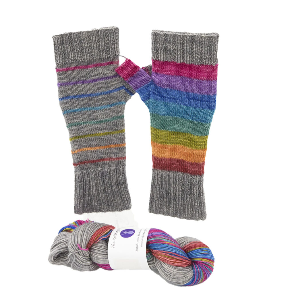 two fingerless mitts, grey with rainbow stripes plus yarn to knit them