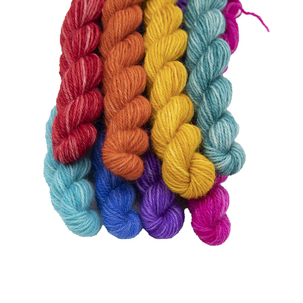set of eight mini Britsock skeins hand dyed in semi solid colours. Each skein is different colour an together the set makes up the colours of the original Pride flag, skeins are in a bundle