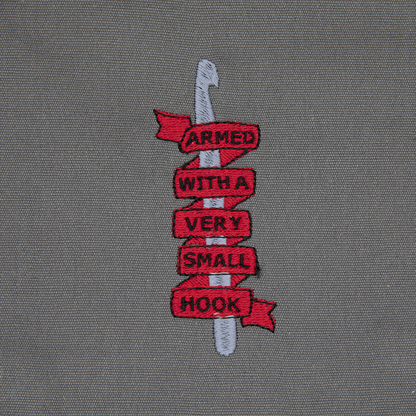 embroidery detail - crochet hook and the words armed with a very small hook