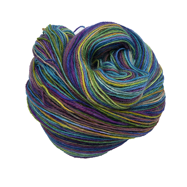 Skein of hand dyed yarn in emerald rainbow