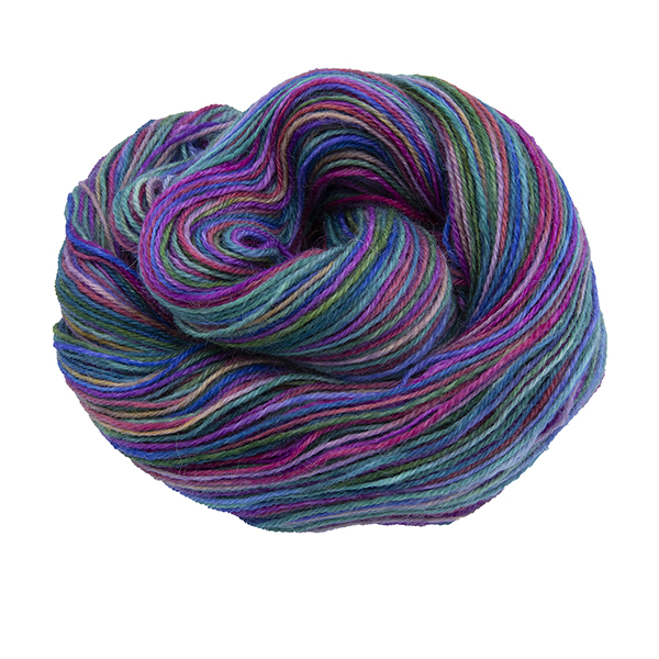 Skein of hand dyed yarn in purple rainbow