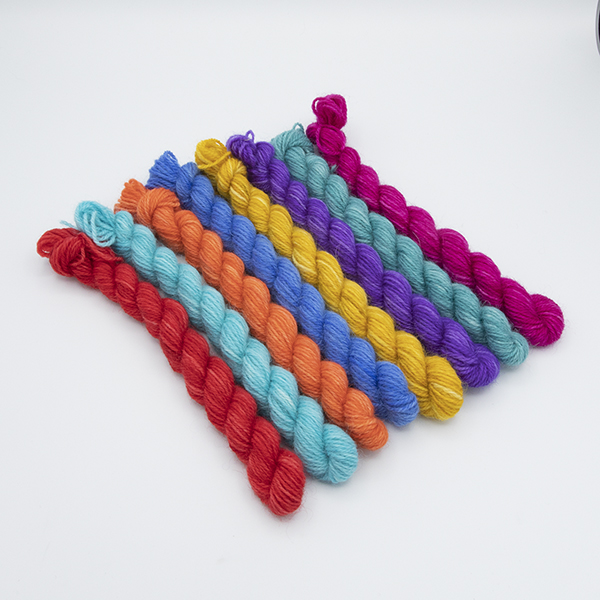 set of eight mini skeins arranged so touching colours contrast