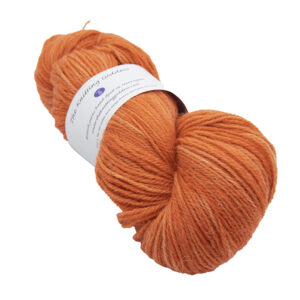 skein of copper orange colour hand dyed Britsock yarn from The Knitting Goddess with ball band