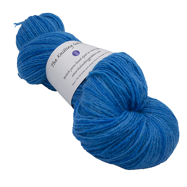 skein of electric blue colour hand dyed Britsock yarn from The Knitting Goddess with ball band