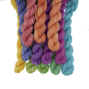 Set of twelve semi solid colours of Britsock mini skeins making up a colour wheel of 12 printer ink hues