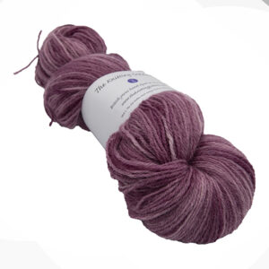 skein of plum colour hand dyed Britsock yarn from The Knitting Goddess with ball band