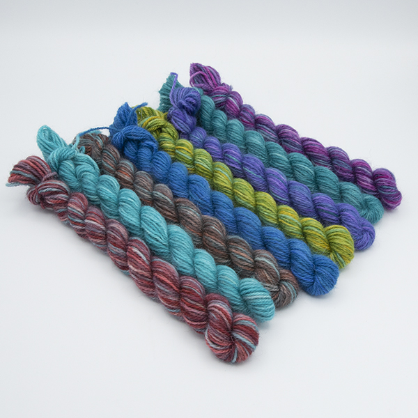 set of eight mini skeins arranged so touching colours contrast