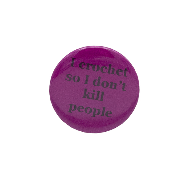 Pink button badge with black writing which reads I crochet so I don't kill people