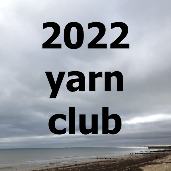 Text 2022 yarn club over a photo of a beach, sea and sky on an overcast day