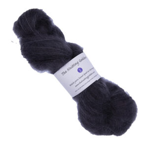 skein of hand dyed fluffy yarn in black with The Knitting Goddess label
