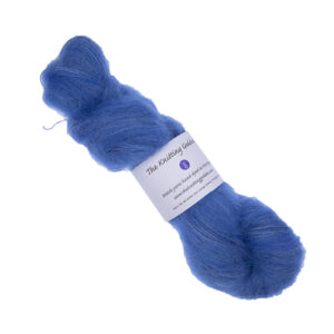 skein of hand dyed fluffy yarn in blue with The Knitting Goddess label