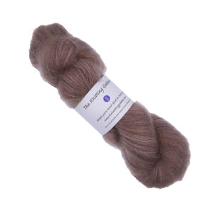 skein of hand dyed fluffy yarn in caramel with The Knitting Goddess label