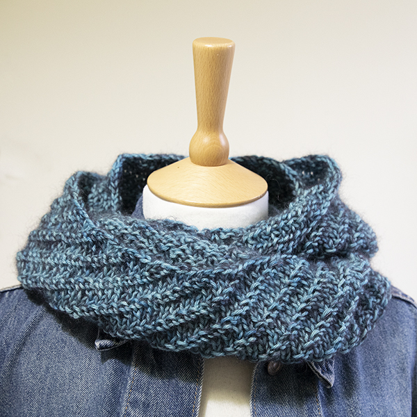 turquoise knitted cowl shown on a mannequin