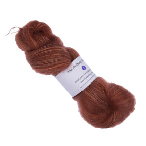 skein of hand dyed fluffy yarn in copper with The Knitting Goddess label