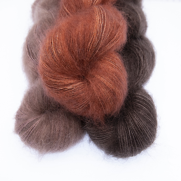 three skeins of fluffy hand dyed Moonbroch yarn in caramel, chocolate and copper