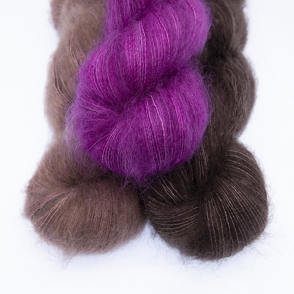 three skeins of fluffy hand dyed Moonbroch yarn in caramel, chocolate and raspberry