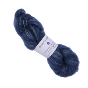 skein of hand dyed fluffy yarn in navy with The Knitting Goddess label