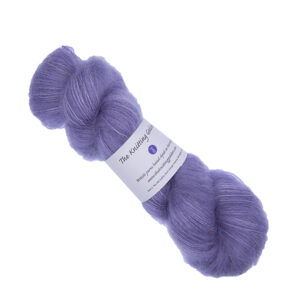 skein of hand dyed fluffy yarn in violet with The Knitting Goddess label