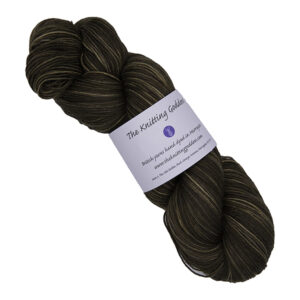 skein of darkest gold hand dyed yarn with The Knitting Goddess label