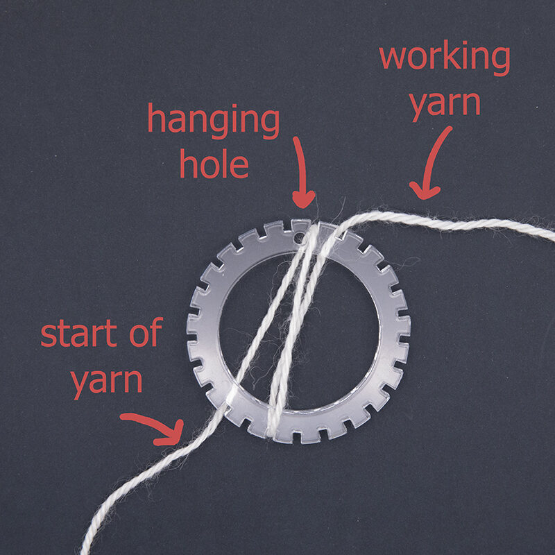 small circular loom showing start of yarn wrapping