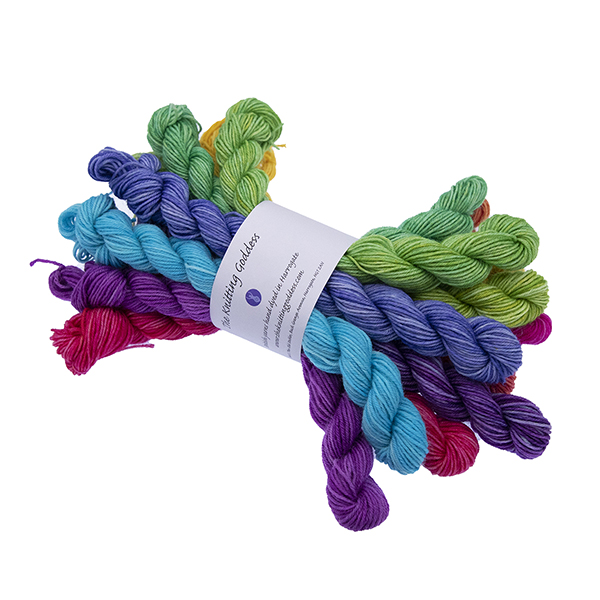 12 mini skeins in colour wheel order from turquoise through to green. Bundled with The Knitting Goddess ball band