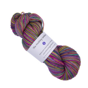 skein of hand dyed multi coloured yarn in purple rainbow. Pink, orange, yellow, green,turquoise and purple, all overdyed with purple with The Knitting Goddess ball band