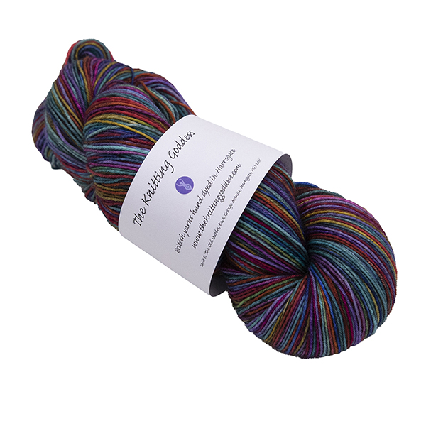 skein of dark rainbow self striping yarn by The Knitting Goddess