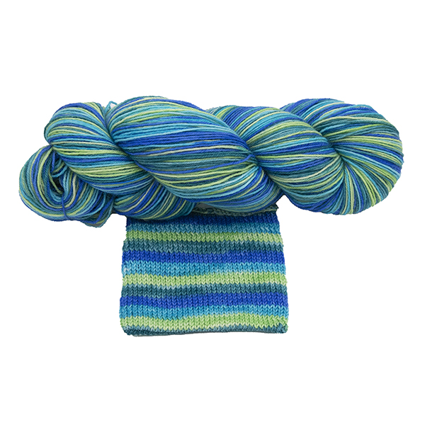 skein of green ocean self striping yarn with jade, lime, turquoise and blue hand dyed by The Knitting Goddess