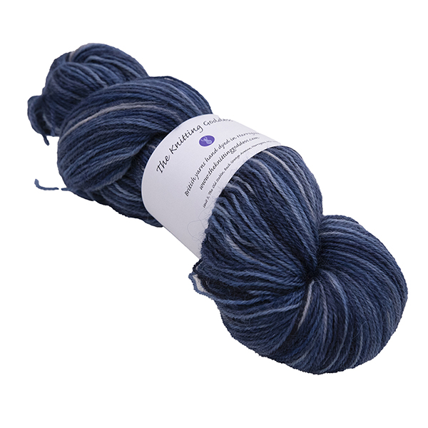 skein of hand dyed britsock yarn in superhero genes forever with dark blue and light grey