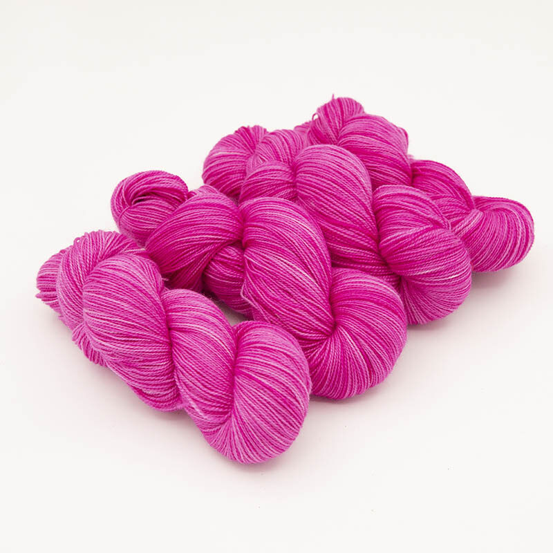 four skeins of bright pink yarn for skint skeins, high twist