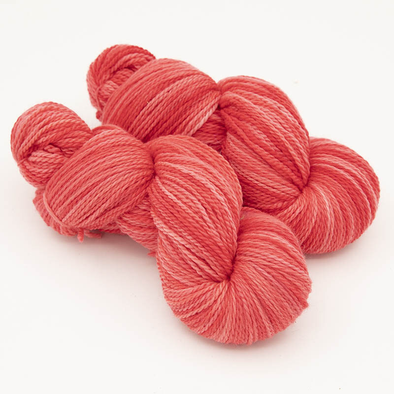 Two skeins of red yarn for skint skeins, plied