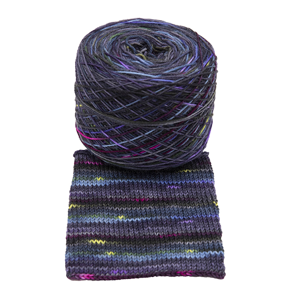 Ball of self striping sock yarnHope ~ the light within the dark , dark grey, purple and blue with speckles of bright pink, gold and lilac, shown with knitted sample