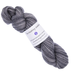 elephant grey skein of hand dyed yarn with The Knitting Goddess ball band