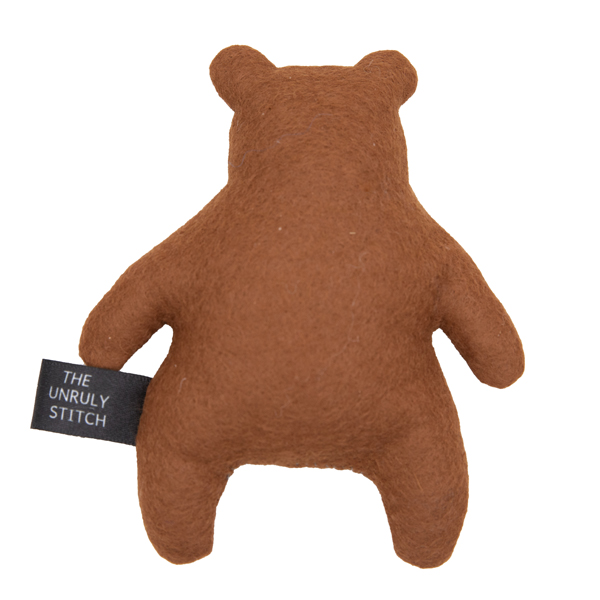 back view of brown felt bear, label reads THE UNRULY STITCH