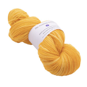 hand dyed DK sock yarn in marigold yellow with The Knitting Goddess ball band
