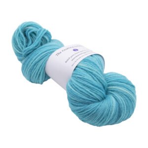 hand dyed DK sock yarn in turquoise with The Knitting Goddess ball band