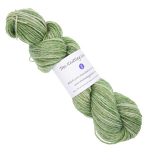 lime green skein of hand dyed yarn with The Knitting Goddess ball band