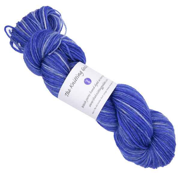 violet blue skein of hand dyed yarn with The Knitting Goddess ball band