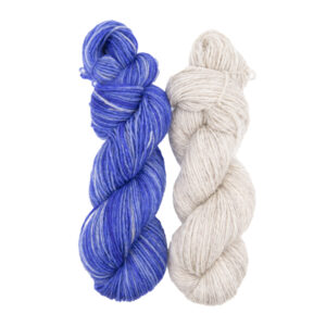 two skeins of hand dyed yarn, one violet blue, the other pale silver