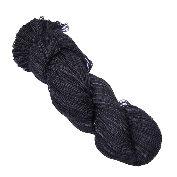 black skein of hand dyed wool and silk yarn with The Knitting Goddess ball band