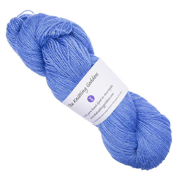 blue skein of hand dyed wool and silk yarn with The Knitting Goddess ball band