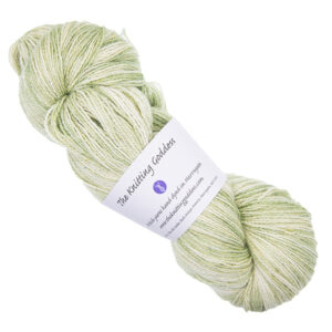 pale moss green skein of hand dyed wool and silk yarn with The Knitting Goddess ball band
