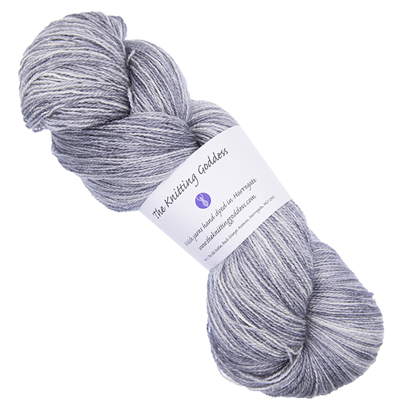 silver skein of hand dyed wool and silk yarn with The Knitting Goddess ball band