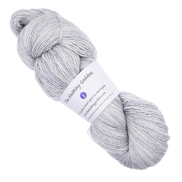 pale silver skein of hand dyed wool and silk yarn with The Knitting Goddess ball band