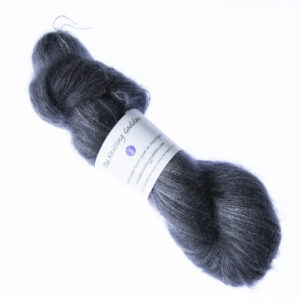 Coal hand dyed fluffy mohair silk yarn in a skein with The Knitting Goddess ball band