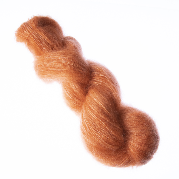 Copper hand dyed fluffy mohair silk yarn in a skein