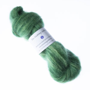Forest Green hand dyed fluffy mohair silk yarn in a skein with The Knitting Goddess ball band