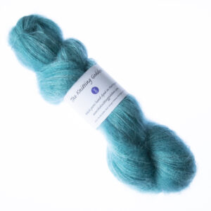 Green hand dyed fluffy mohair silk yarn in a skein with The Knitting Goddess ball band