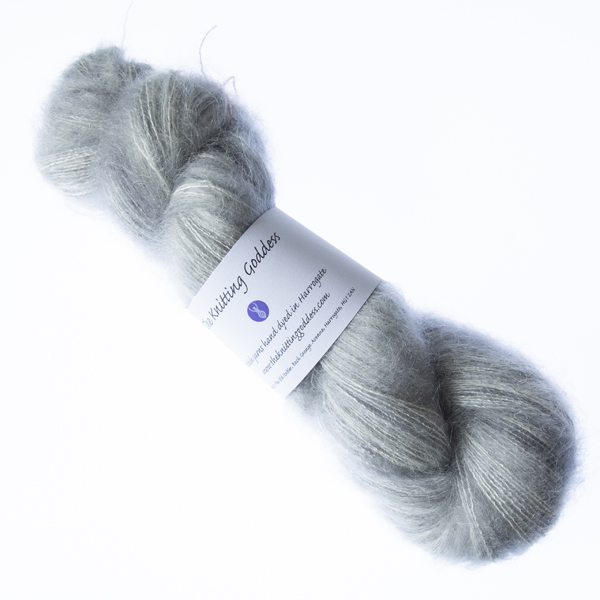 Pearl hand dyed fluffy mohair silk yarn in a skein with The Knitting Goddess ball band